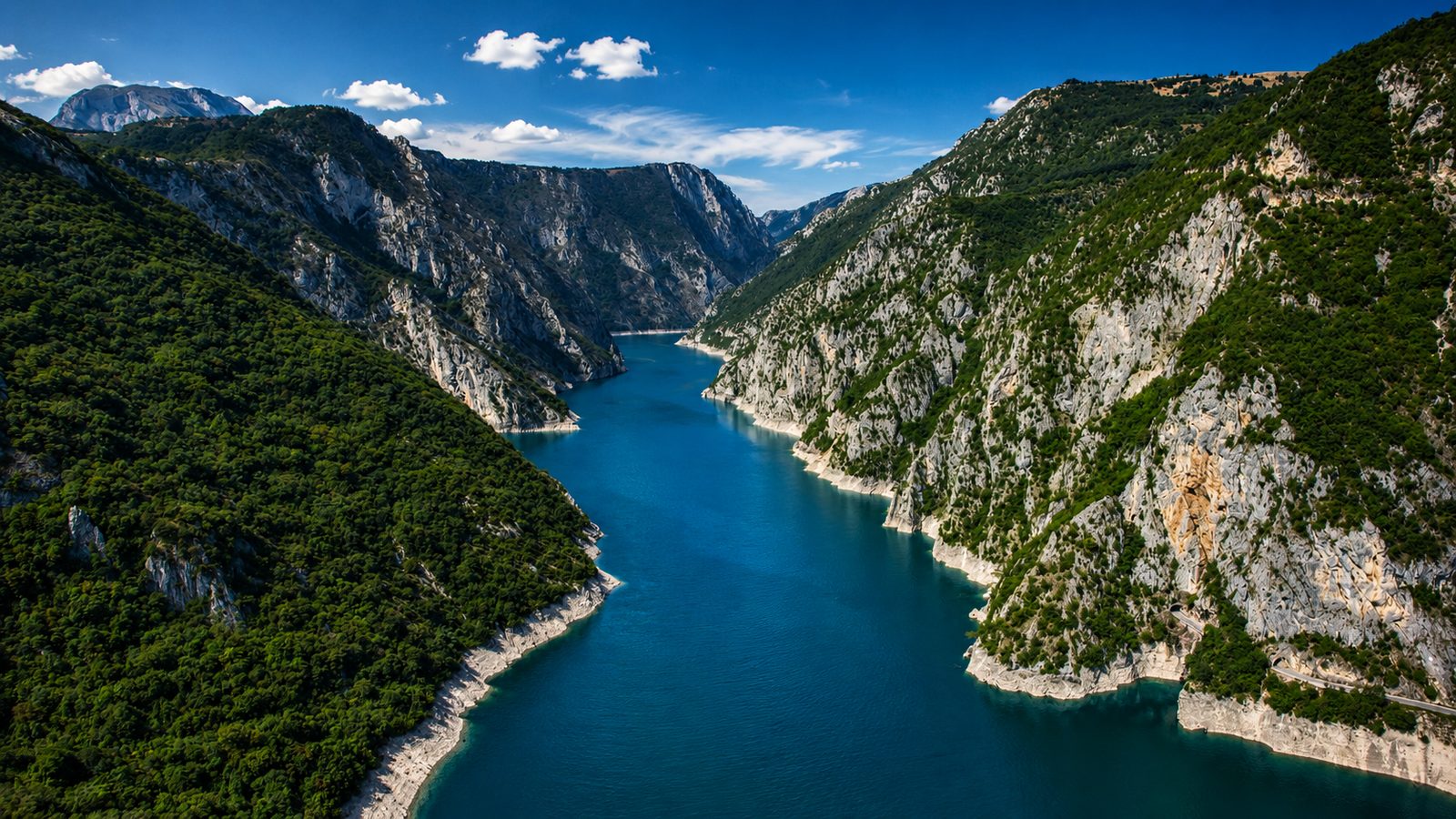 Piva Lake with turquoise water, canyon cliffs and mountains around Plužine