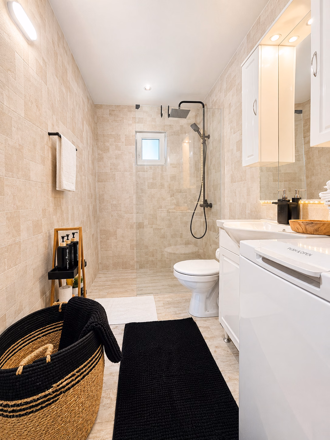 Cabin bathroom with walk-in shower, sink and washing machine