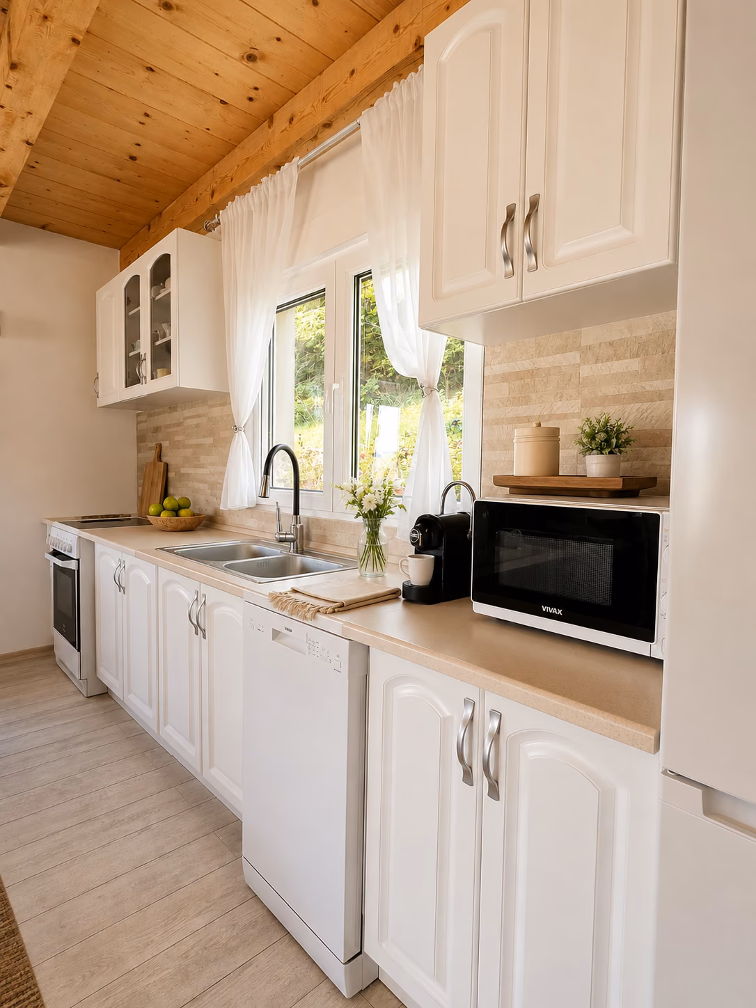 Fully equipped cabin kitchen with stove, dishwasher, microwave and coffee machine